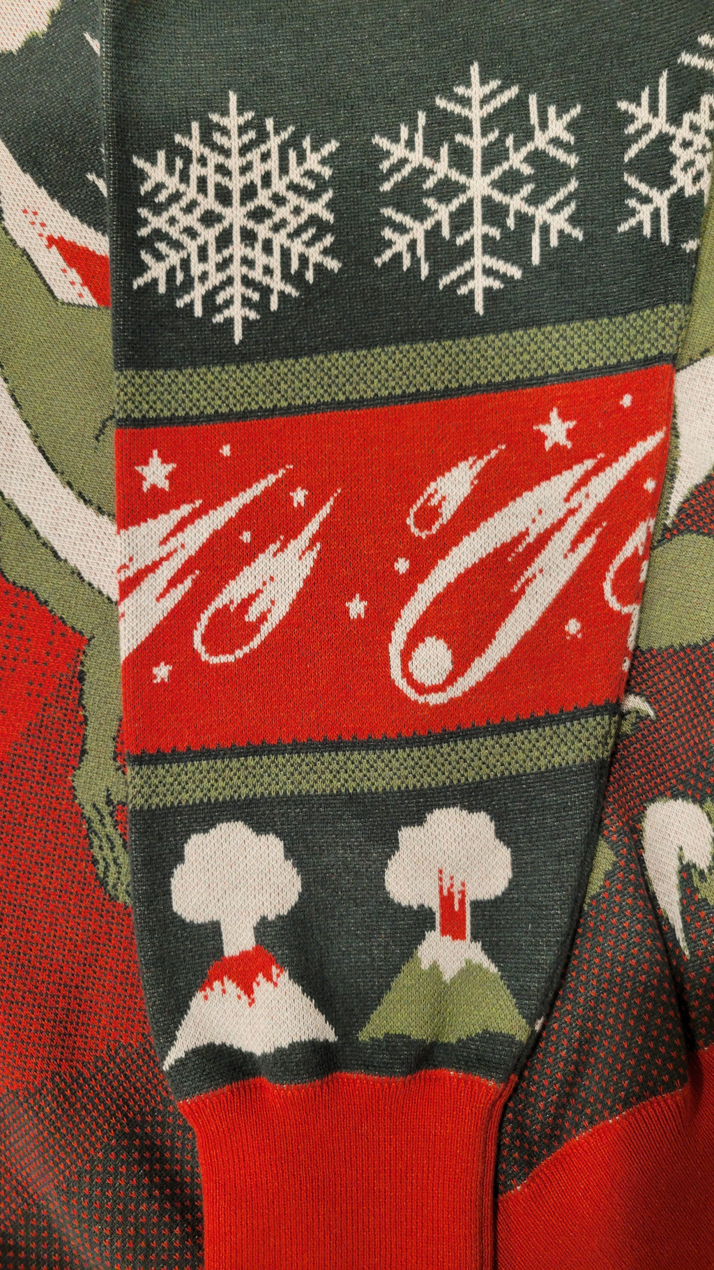 Close-up of a sleeve with snowflakes, meteors, and volcanoes.