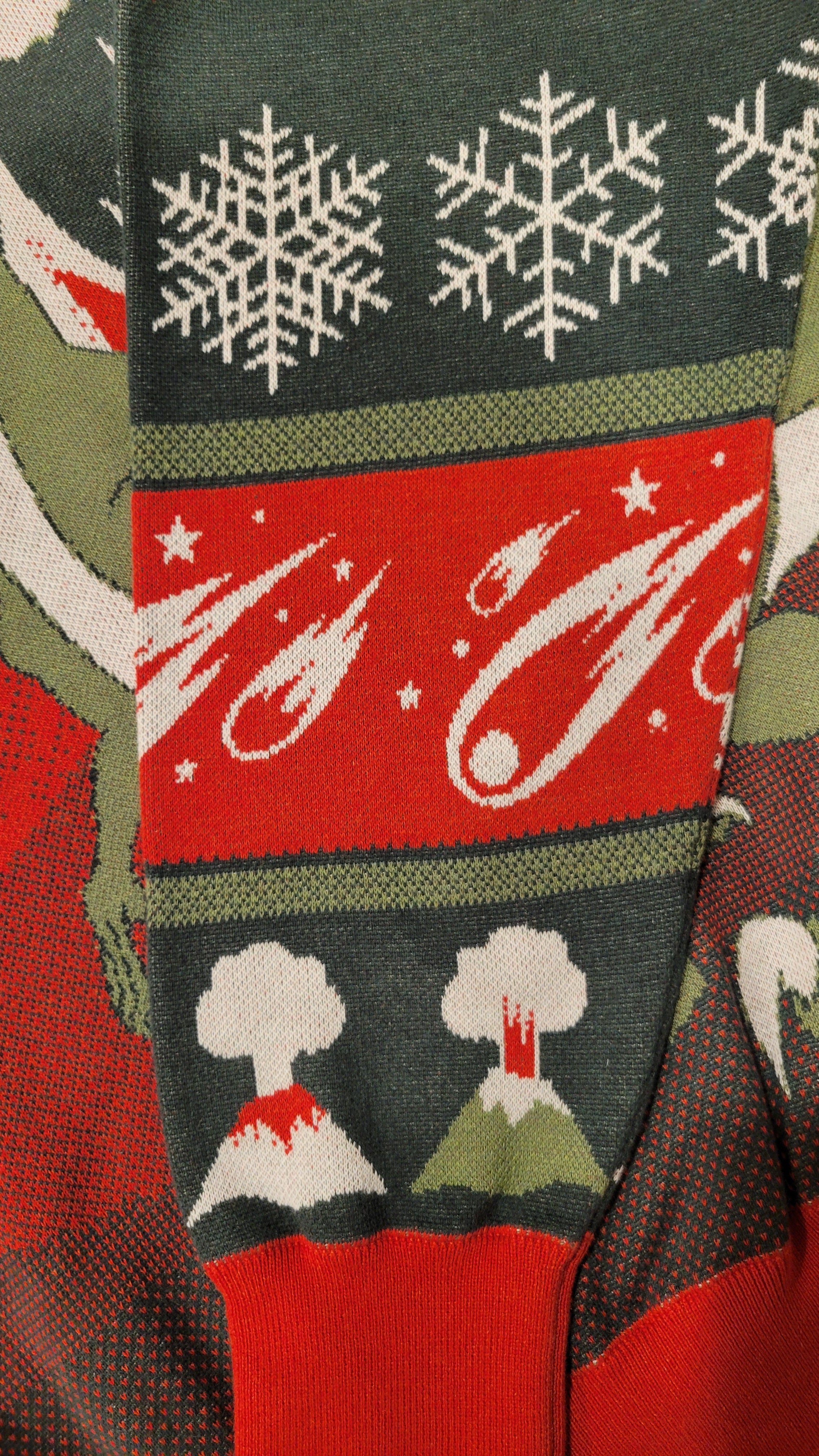 Close-up of a sleeve with snowflakes, meteors, and volcanoes.